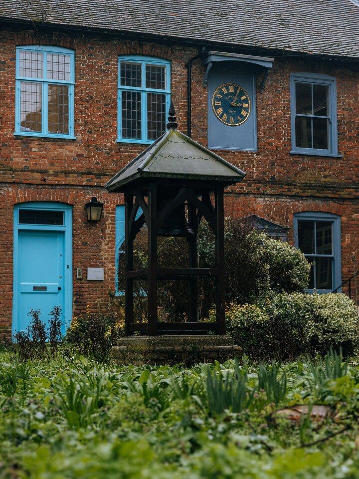 a small building with a clock on the front of it